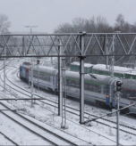 stock-photo--kolobrzeg-west-pomeranian-poland-january-a-passenger-train-going-against-the-2578873855(1)